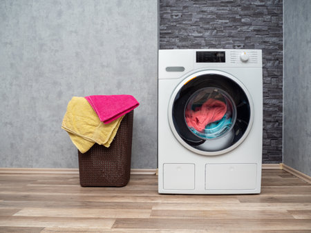 Laundry room interior with washing machine against the wall. Modern washing machine.の写真素材