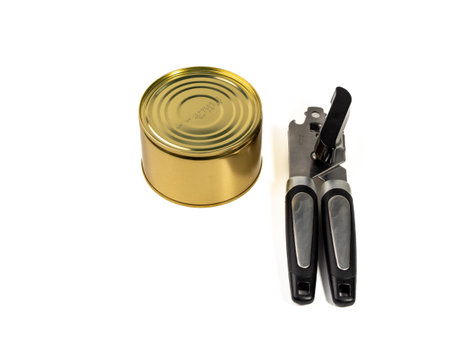 Can opener with tin can isolated on white background. Metal can opener. Close up.の写真素材