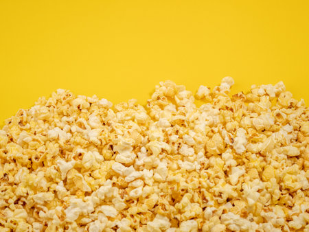 Popcorn on a yellow background. Sweet popcorn on yellow. Close up.の写真素材