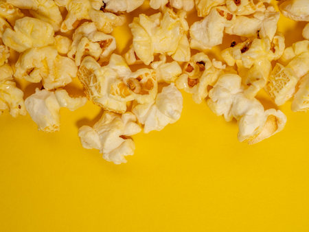 Popcorn on a yellow background. Sweet popcorn on yellow. Close up.の写真素材