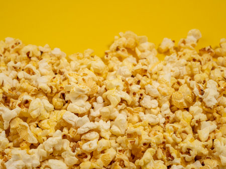 Popcorn on a yellow background. Sweet popcorn on yellow. Close up.の写真素材