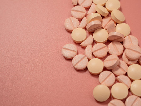 Pink pills on a pink background. Medical tablets. Pills close up.の写真素材