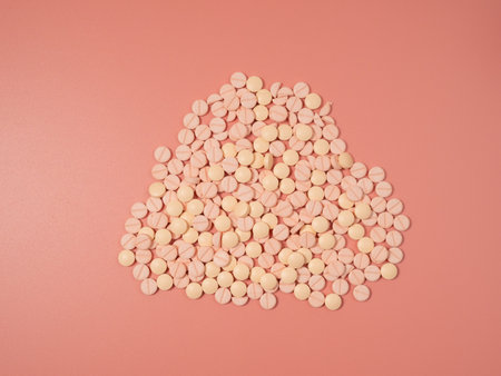 Pink pills on a pink background. Medical tablets. Pills close up.の写真素材