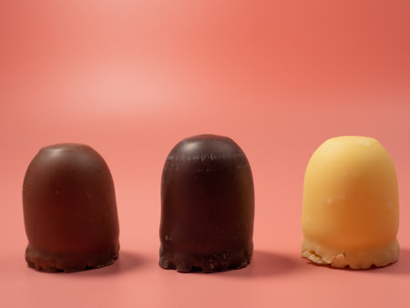 Chocolate covered marshmallow on a pink background. Close up.の写真素材