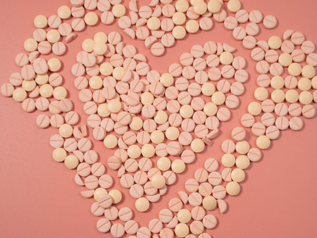 Pink pills on a pink background. Medical tablets. Pills close up.の写真素材