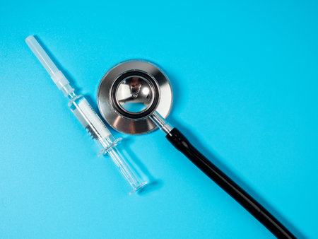 Injection vaccine on a blue background, medicine concept. On the syringe is applied: vaccination for adults and expiration date.の写真素材