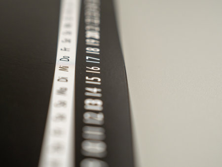 Close-up of a black calendar page with push pins. Time concept.の写真素材