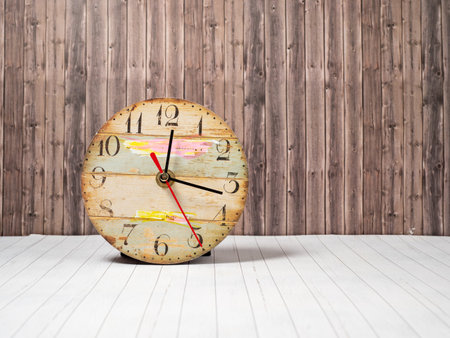 Retro clock on a wooden background. Clock close up.