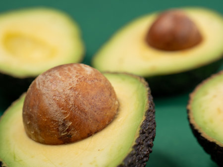 Avocado on a green background. Ripe avocado.
