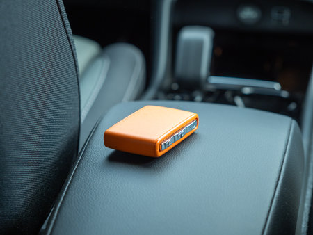 Car ignition key on the armrest in the interior of a modern car. Forgot my keys in the car.