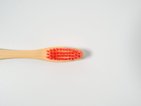 Bamboo toothbrush. Wooden toothbrush on a white background. Toothbrush close up.の写真素材