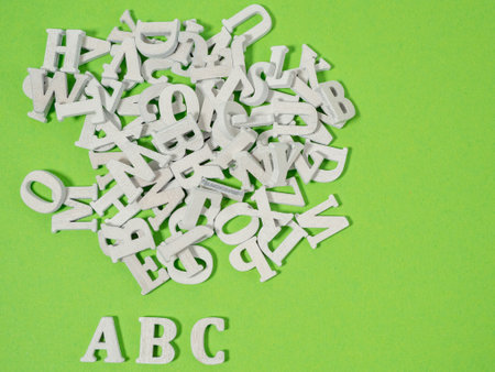 Wooden letters on a green background. Wooden letters abc concept of school and learning.の写真素材