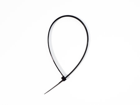 Plastic black ties on a white background. Plastic ties for cables.