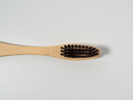 Bamboo toothbrush. Wooden toothbrush on a white background. Toothbrush close up.