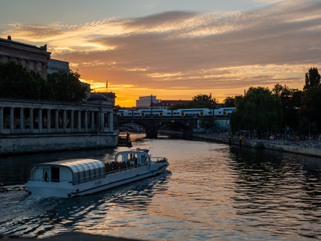 View of the city river, on which the boat floats at sunset. Landscape of the evening cityの写真素材