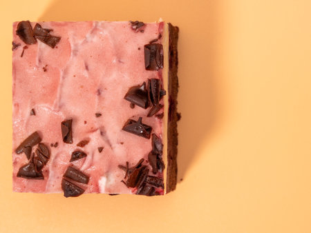 Cherry cake with chocolate on an orange background. Cream cake with cherries and chocolate.の写真素材