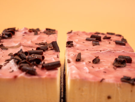 Cherry cake with chocolate on an orange background. Cream cake with cherries and chocolate.の写真素材