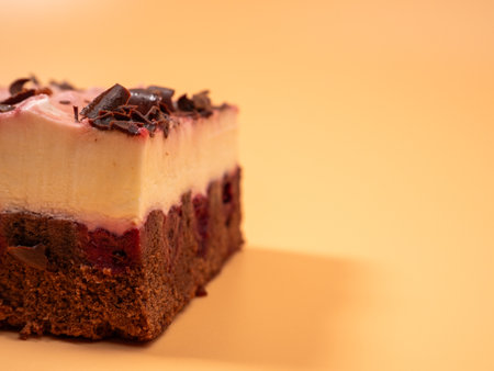 Cherry cake with chocolate on an orange background. Cream cake with cherries and chocolate.の写真素材