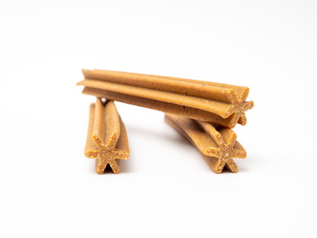Dog chewing sticks on a white background. Treats for dogs.の写真素材