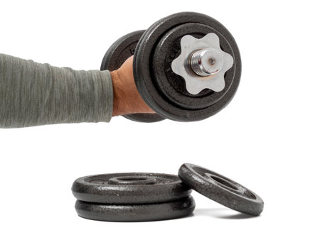 In hand there is a dumbbell on a white background. Dumbbells close up.の写真素材