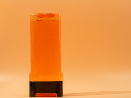 Bottle of liquid shower gel on an orange background. Shower gel close-up.の写真素材