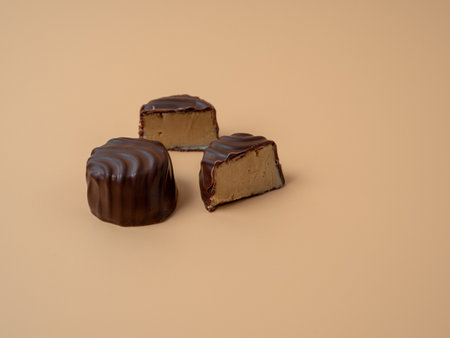 Chocolate candies on an orange background. Chocolate candies close-up.の写真素材