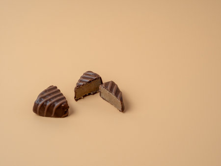 Chocolate candies on an orange background. Chocolate candies close-up.の写真素材