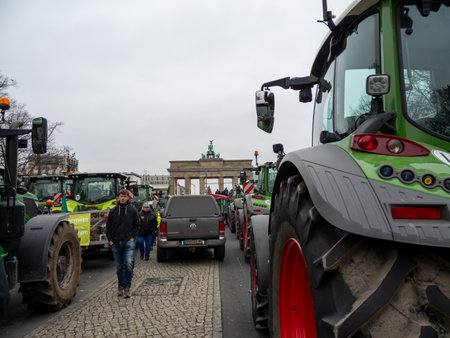Berlin, Germany December 18. 2023 Farm tractors with the Brandenburg Gate in the background. Berlin, Germany December 18, 2023のeditorial素材