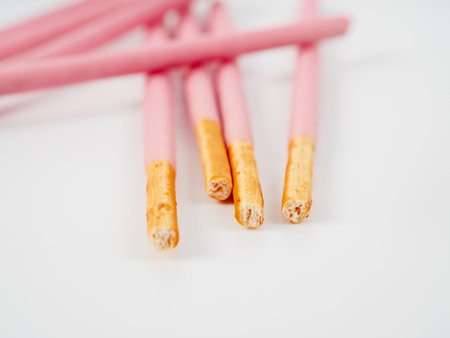 Crispy sticks in pink sugar glaze. Sticks in berry pink glaze on a white background.の写真素材