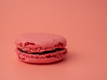 Colorful French macaroons on a pink background. French macaroons close-up.