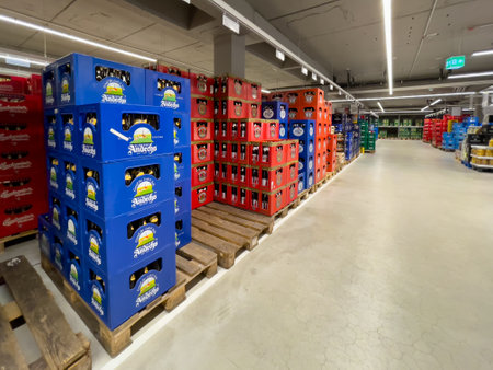 Germany Berlin May 11, 2024. A store with many different colored boxes of beer. The blue boxes are on the left and the red boxes are on the rightのeditorial素材