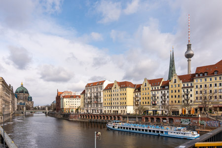 Germany Berlin March 24, 2024. A city with a river running through it and a tall tower in the...