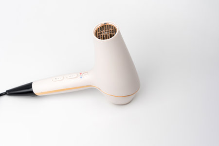 Hair dryer for drying hair on a white background. The buttons are labeled "cold" and "warm".の写真素材