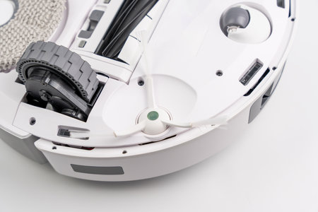 A white robot with a green wheel on the bottomの写真素材