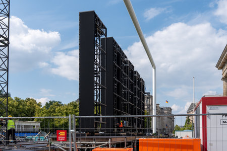 Germany Berlin June 07, 2024 Installation of a large television screen in front of the football match at the Brandenburg Gate. Installation of decorations..のeditorial素材