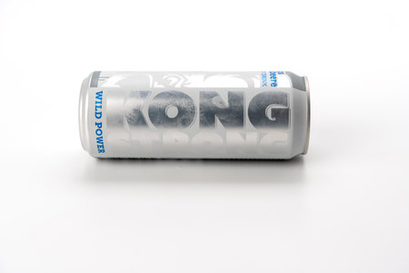 A can of energy drink stands on a white background. The jar is silver, with a blue label.