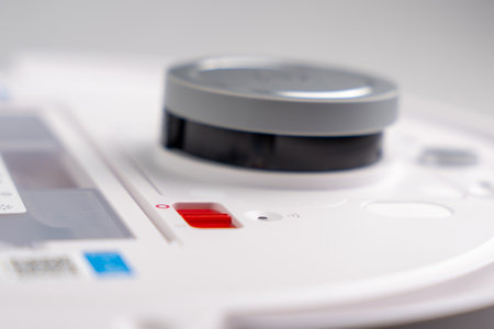 A white device with a red button on the side. The button is labeled "off." The device is likely a remote control for a device such as a television or a video game consoleの写真素材