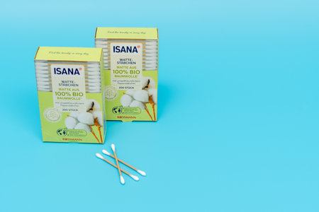 Germany Berlin July 20, 2024. Boxes of cotton swabs from Isana on a blue background. Bio sticks.のeditorial素材