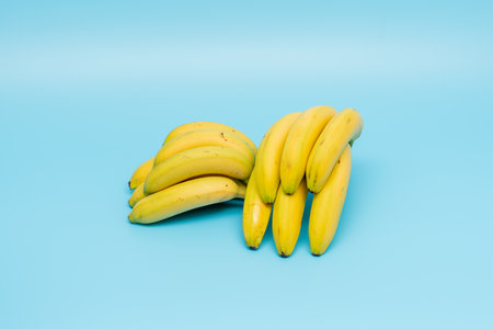 Ripe bananas on a blue background. Bananas close-up. Space for text.