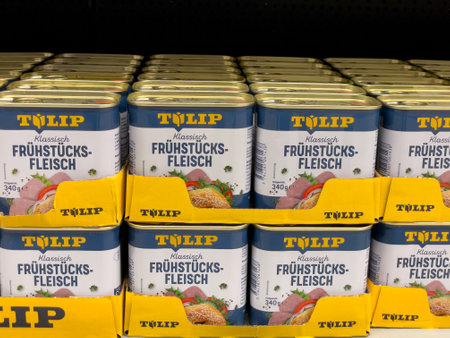 A stack of canned food with the brand name Tulip. The cans are filled with a meat and vegetable mixtureのeditorial素材