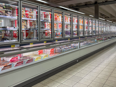 Germany Berlin August 31, 2024. Large supermarket with rows of products and a freezer. The freezer is full of frozen food.のeditorial素材