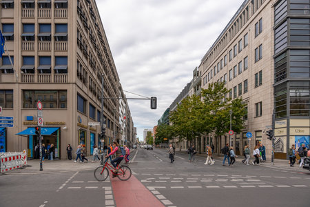 Germany Berlin September 15, 2024. A busy city street with a red bike lane and a blue sign. People...