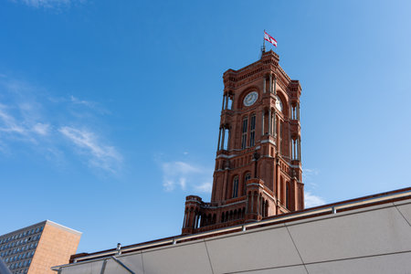 Tall red clock tower. Red City Hall of Berlin The sky is blue and there are no clouds.の写真素材