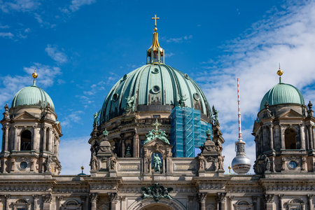 The blue dome of a building is visible in the sky. The building is a church with a tall tower Berlin Cathedral.の写真素材