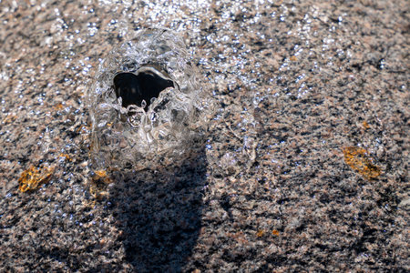 A small hole in the ground with water coming out of it. The water is clear and coldの写真素材