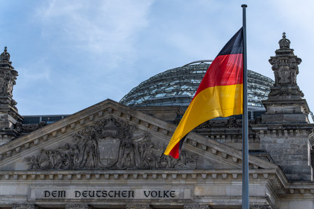 Close-up of German flags fluttering over the Reichstag. German flags against the sky.の写真素材