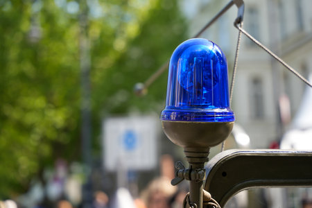 Blue rotating beacon on a historic military or emergency vehicle photographed in sunlight. Flashing beacon on a vintage military vehicle.の写真素材