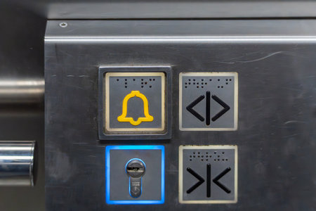 Detailed shot of an elevator with an emergency call button, door control, and key switch. The...