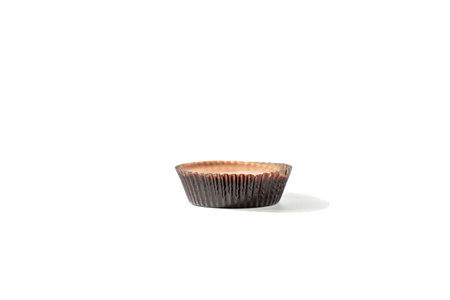A classic chocolate peanut butter cup with a dark shell. Ideal for those who enjoy sweet and savory combinations.の写真素材