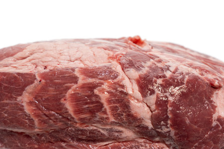 Close-up fat structure marbling. Macro shot of raw pork with distinct marbling. The fat structures suggest a juicy texture. Meat isolated on white background.の写真素材
